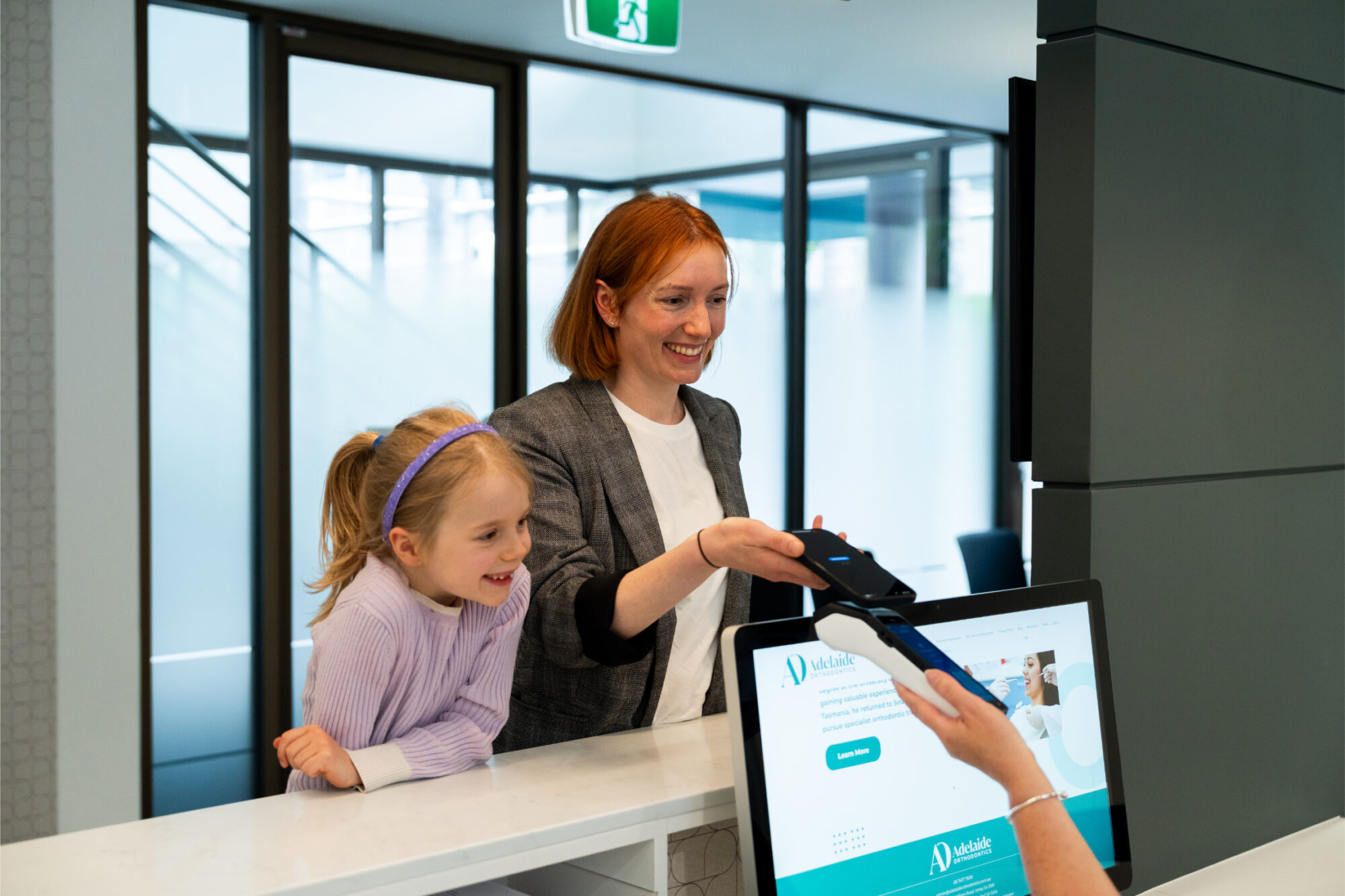 mother and daughter smiling with braces